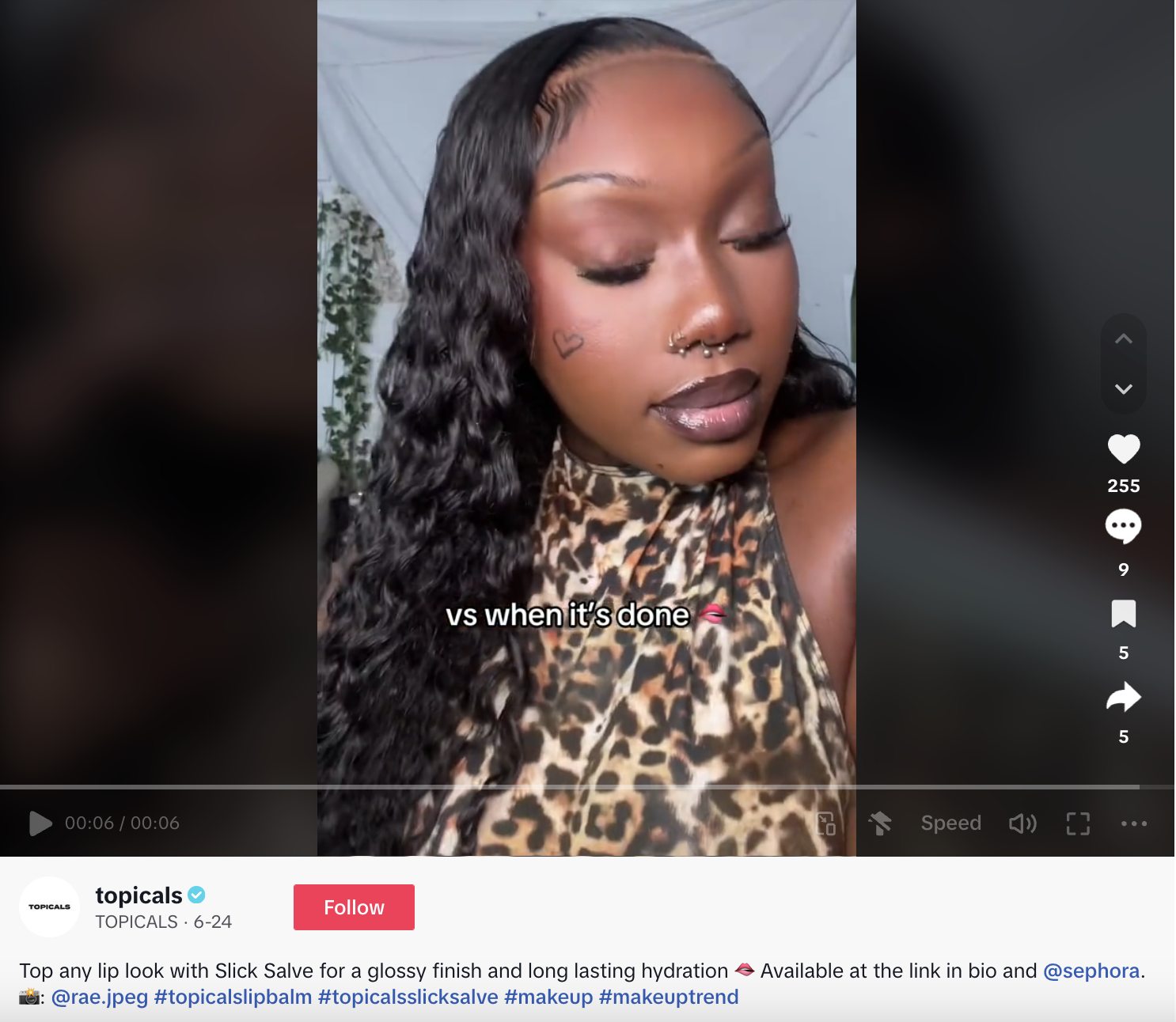 A TikTok video of an influencer applying Topicals Slick Salve lip product